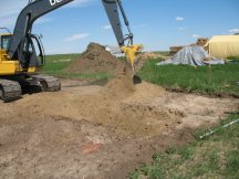 Jock takes his first scoop of the excavation.