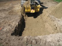 Jock takes his first scoop of the excavation.