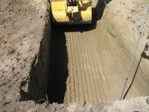 Jock takes his first scoop of the excavation.