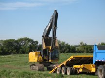 Jock unloads the trackhoe